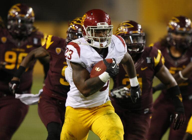 Southern California running back Tre Madden (23) scores a touchdown against Arizona State during the second half of an NCAA college football game on Saturday, Sept. 28 2013, in Tempe, Ariz. (AP Photo/Rick Scuteri)