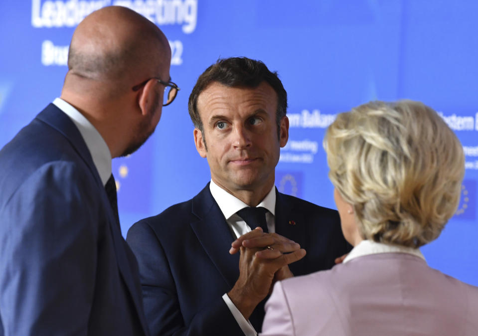 European Commission President Ursula von der Leyen, right, speaks with French President Emmanuel Macron, center, and European Council President Charles Michel prior to a group photo with Western Balkan leaders at an EU summit in Brussels, Thursday, June 23, 2022. European Union leaders are expected to approve Thursday a proposal to grant Ukraine a EU candidate status, a first step on the long toward membership. The stalled enlargement process to include Western Balkans countries in the bloc is also on their agenda at the summit in Brussels. (John Thys, Pool Photo via AP)
