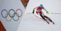 Canada's Michael Janyk clears a pole as he competes in the first run of the men's alpine skiing slalom event during the 2014 Sochi Winter Olympics at the Rosa Khutor Alpine Center February 22, 2014. REUTERS/Leonhard Foeger (RUSSIA - Tags: SPORT OLYMPICS SPORT SKIING)