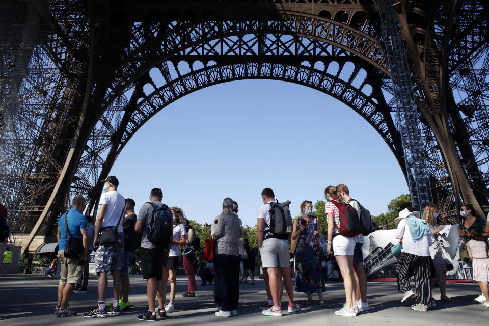 People queue up prior to visit the Eiffel Tower, in Paris, Thursday, June 25, 2020. The Eiffel Tower reopens after the coronavirus pandemic led to the iconic Paris landmark's longest closure since World War II. (AP Photo/Thibault Camus)