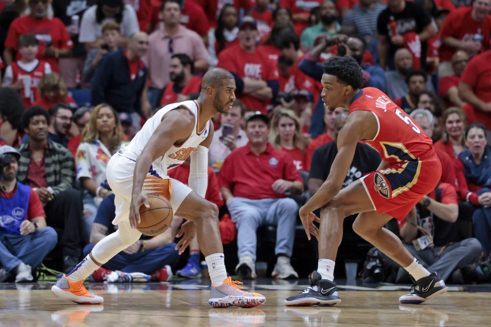 Phoenix Suns guard Chris Paul, left, works against New Orleans Pelicans forward Herbert Jones (5) in the first half of Game 3 of an NBA basketball first-round playoff series in New Orleans, Friday, April 22, 2022. (AP Photo/Michael DeMocker)