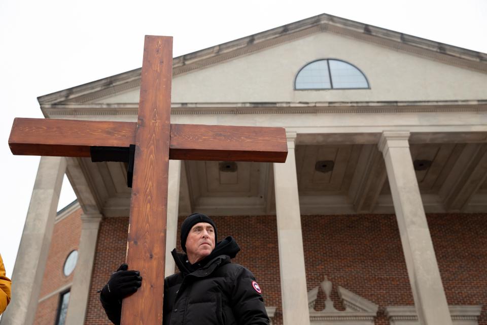 Dan Beazley carries a 10-foot cross outside the Mississippi Boulevard Christian Church in Memphis, Tenn., on Wednesday, Feb. 1, 2023, ahead of the funeral service for Tyre Nichols. 