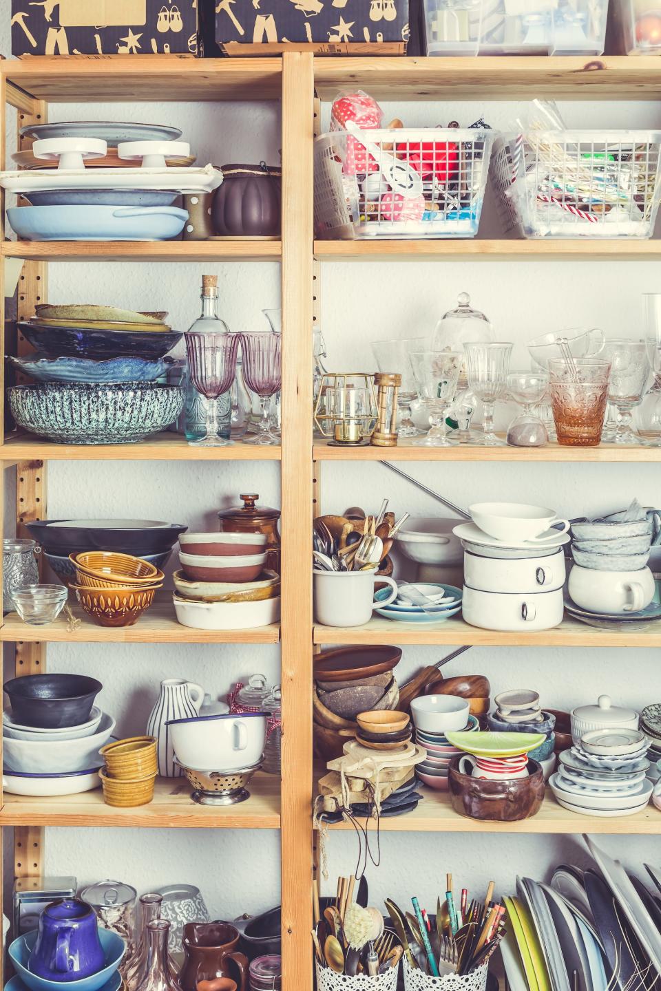 A cabinet full of mismatched glassware.