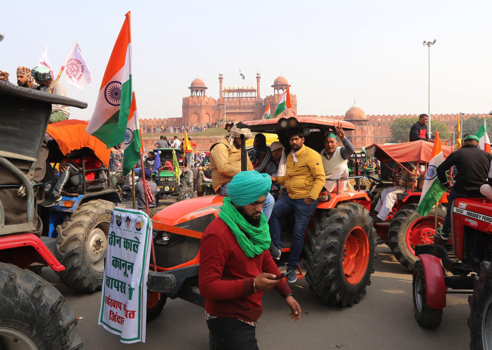 DELHI, INDIA - 2021/01/26: Farmers gathering at Red Fort during the demonstration. Farmers protesting against agricultural reforms breached barricades and clashed with police in the capital on the India's 72nd Republic Day. The police fired tear gas to restrain them, shortly after a convoy of tractors trundled through the Delhi's outskirts. (Photo by Amarjeet Kumar Singh/SOPA Images/LightRocket via Getty Images)