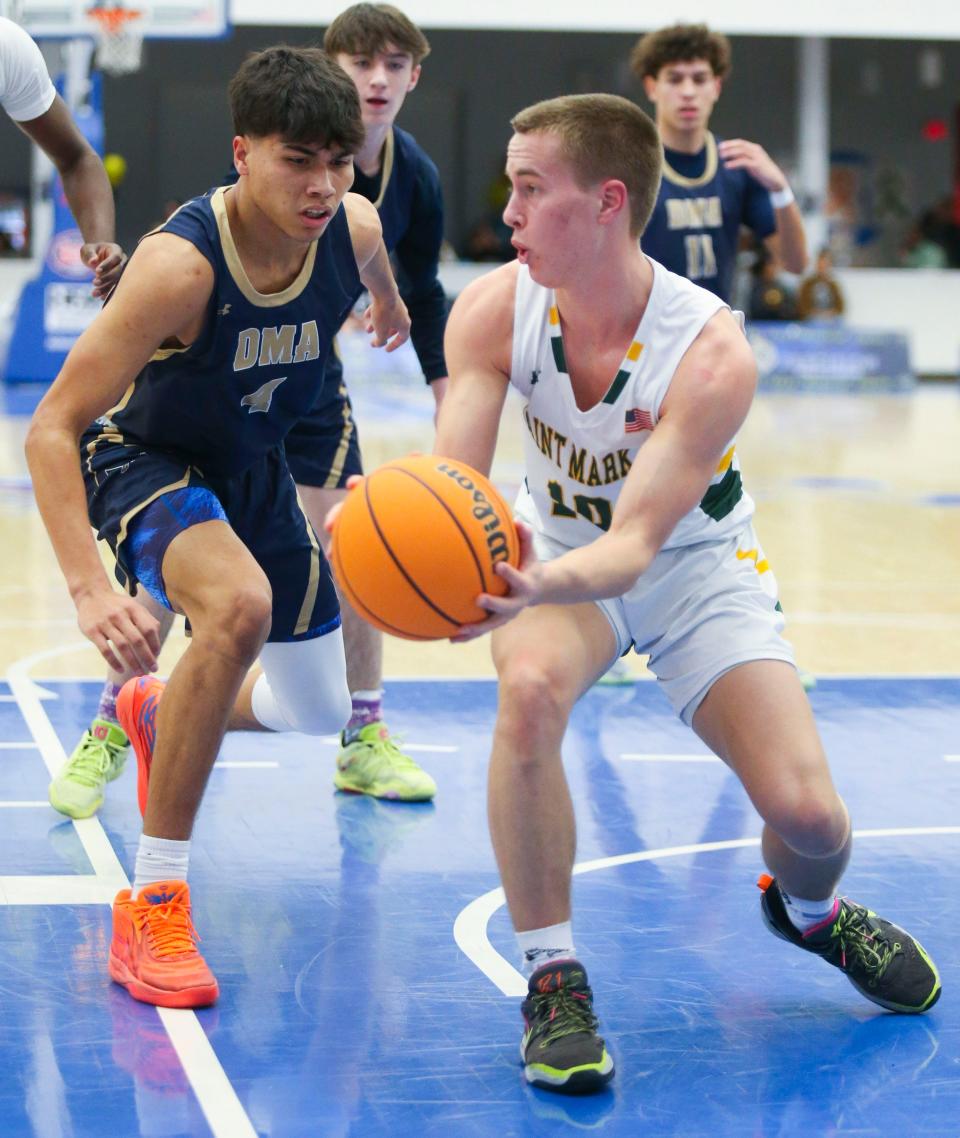 Delaware Military's Roman Hernandez (left) defends as St. Mark's Chad Dohl looks to pass in the second half of St. Mark's 59-50 win in the Fifth Annual SL24 Memorial Classic, Friday, Feb. 3, 2023 at the Chase Fieldhouse. The seven-game, two-day fundraiser for the SL24: UnLocke the Light foundation continues Saturday.
