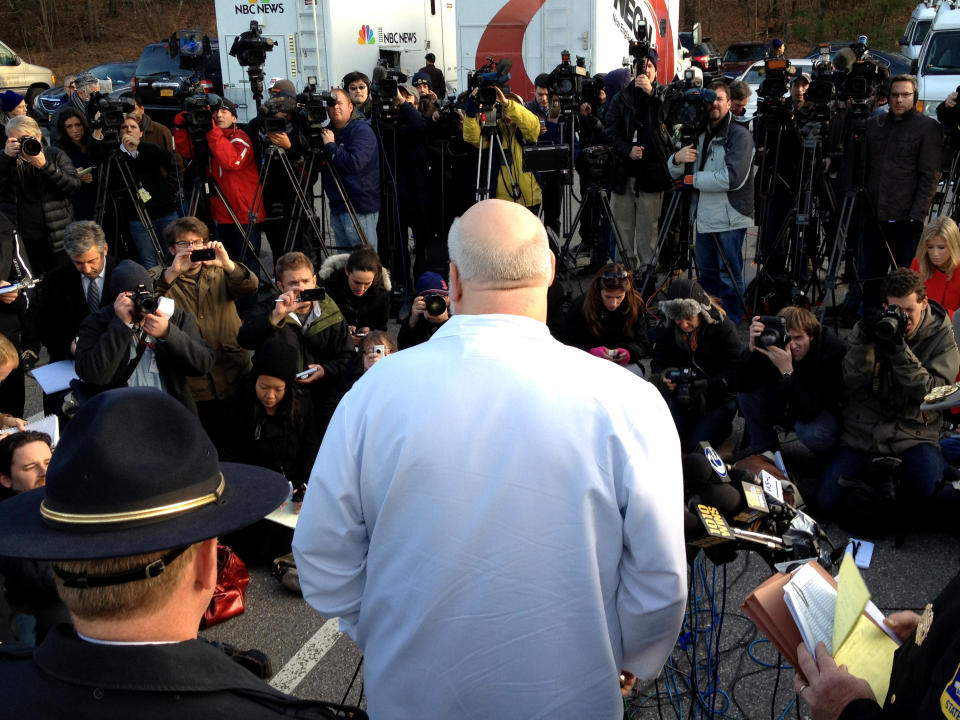 The medical examiner addresses the media in Newtown, Conn.