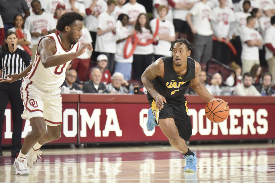 Arkansas-Pine Bluff guard Kylen Milton, right, pushes past Oklahoma guard Le'Tre Darthard, left, during the second half of an NCAA college basketball game in Norman, Okla., Thursday, Nov. 30, 2023. (AP Photo/Kyle Phillips)