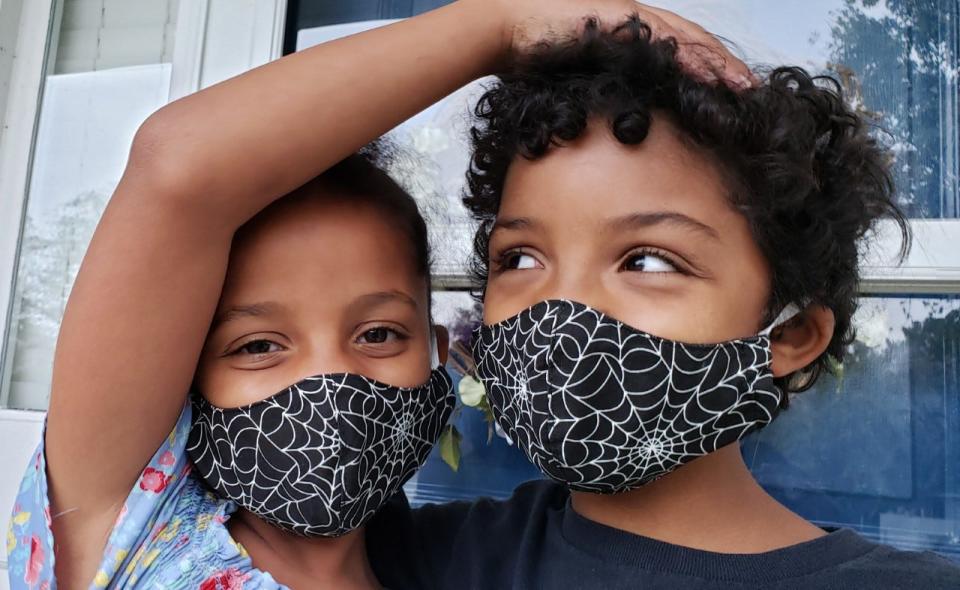 Helen Ann and Samuel, in Halloween-themed masks that their grandmother made, on Oct. 28, 2021. They were the days when cloth masks ruled, before health officials began recommending N95s and KN95s.