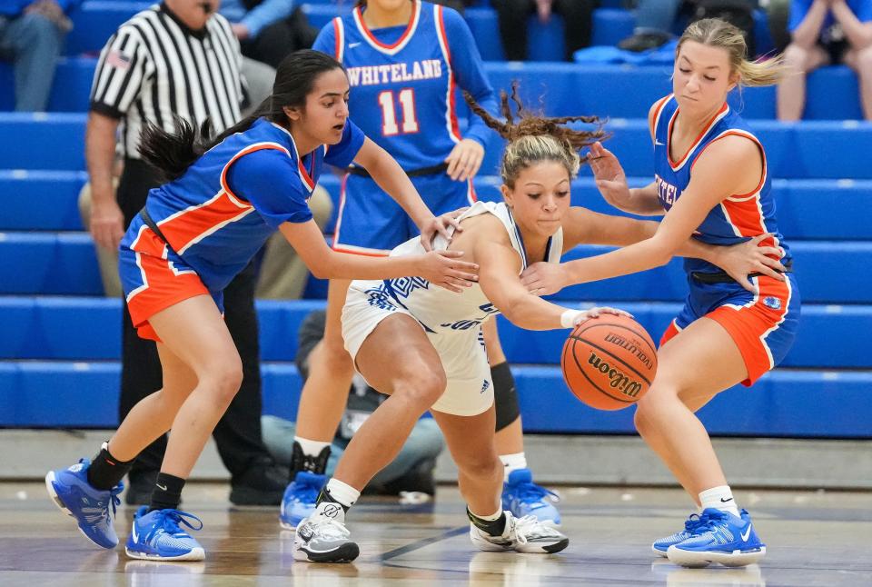 Franklin Community Grizzley Cubs Aubrey Runyon (1) reaches for the ball against Whiteland's guard Addison Emberton (15) and Whiteland's guard Sukhman Bains (5) on Thursday, Nov. 16, 2023, during the semifinals of the Johnson County Tournament at Franklin Community High School in Franklin. The Franklin Community Grizzley Cubs defeated the Whiteland, 68-30.