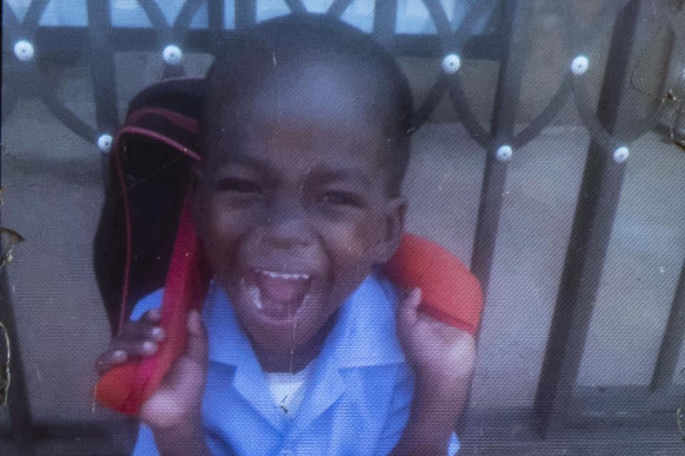 This photo of Wandi Zitho is seen on the mobile phone of his mother, Amanda Zitho, on April 30, 2020, two days after his funeral. The 5-year-old was found dead in his neighbor's tavern in Orange Farm, South Africa. The neighbor was charged with the killing but she was released because the police didn’t deliver enough evidence. Months later, she was arrested again and charged with murdering two other children. (Courtesy of Amanda Zitho via AP)