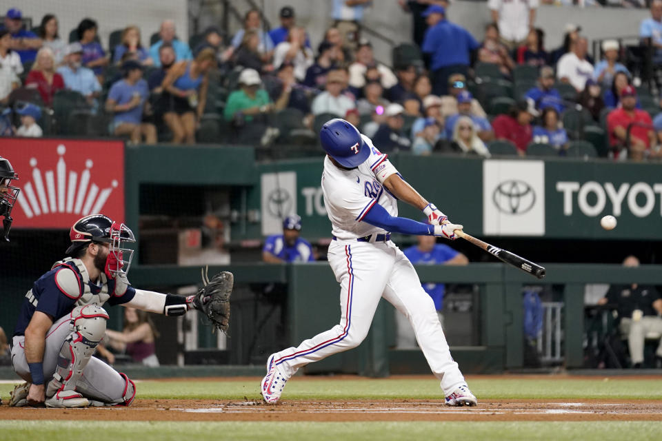 Texas Rangers' Marcus Semien connects for a lead-off solo home run as Boston Red Sox catcher Connor Wong looks on in the firts inning of a baseball game in Arlington, Texas, Monday, Sept. 18, 2023. (AP Photo/Tony Gutierrez)