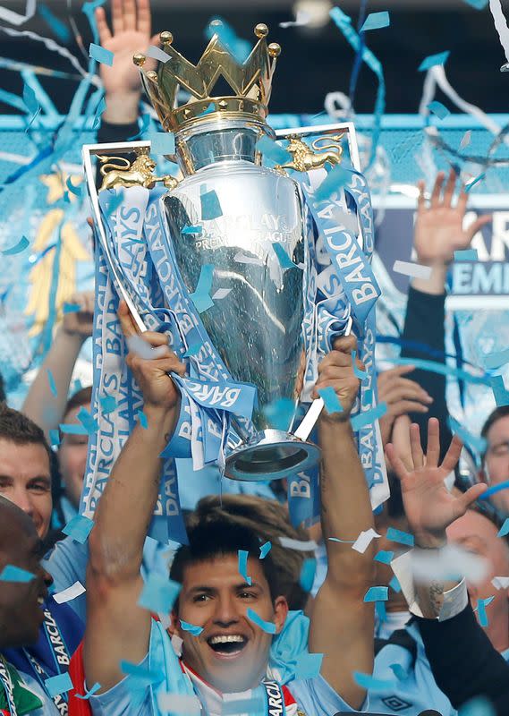 FILE PHOTO: Manchester City's Aguero lifts the English Premier League trophy following their soccer match against Queens Park Rangers in Manchester