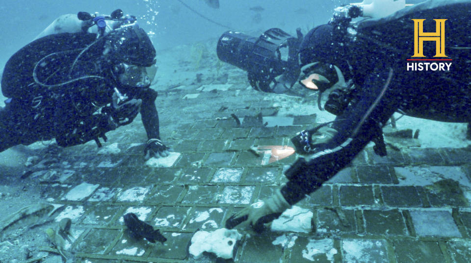 In this photo provided by the History Channel, underwater explorer and marine biologist Mike Barnette and wreck diver Jimmy Gadomski explore a 20-foot segment of the 1986 Space Shuttle Challenger that the team discovered in the waters off the coast of Florida. / Credit: / AP