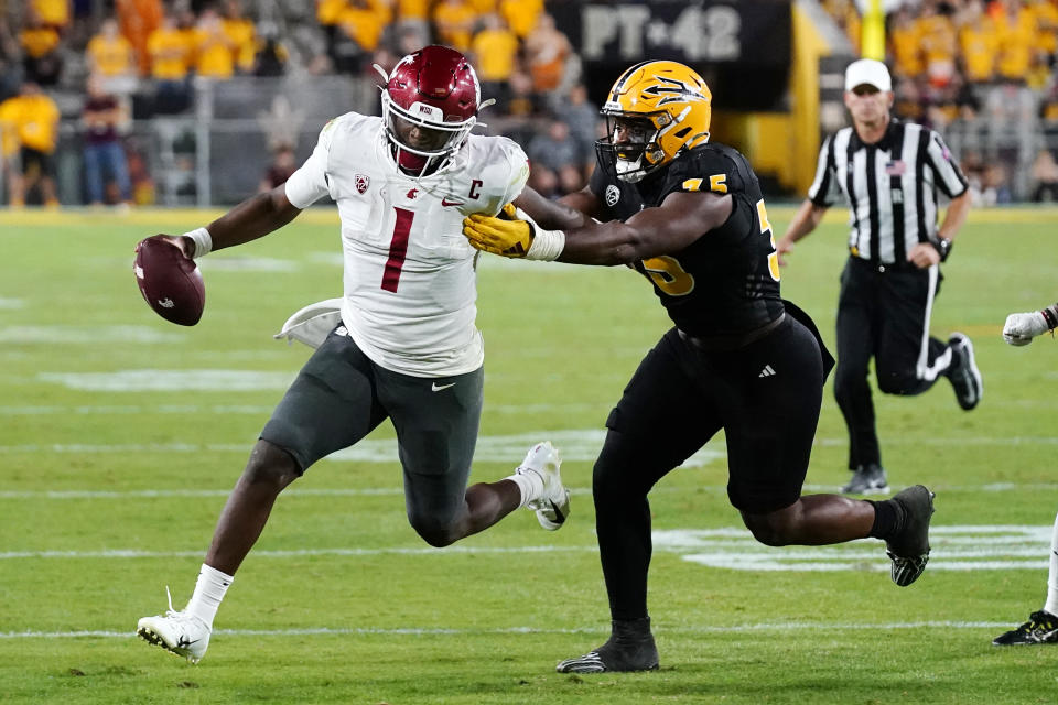 Washington State quarterback Cameron Ward (1) gets stopped by Arizona State defensive lineman B.J. Green II (35) during the second half of an NCAA college football game Saturday, Oct. 28, 2023, in Tempe, Ariz. (AP Photo/Ross D. Franklin)