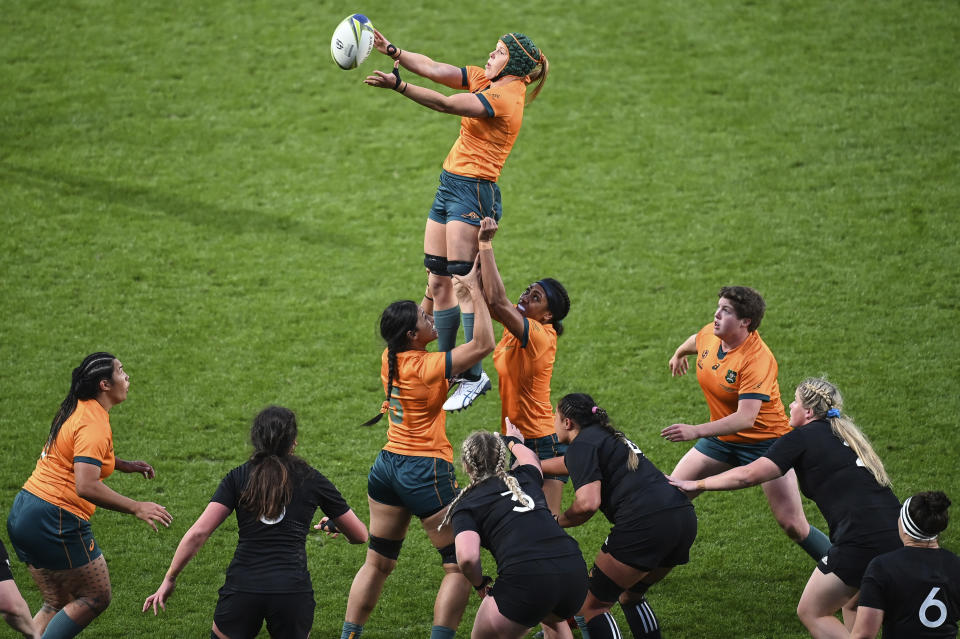 Emily Chancellor of Australia is held aloft by teammates as she wins a line out during the Women's Rugby World Cup pool match between Australia and New Zealand, at Eden Park, Auckland, New Zealand, Saturday, Oct.8. 2022. (Andrew Cornaga/Photosport via AP)