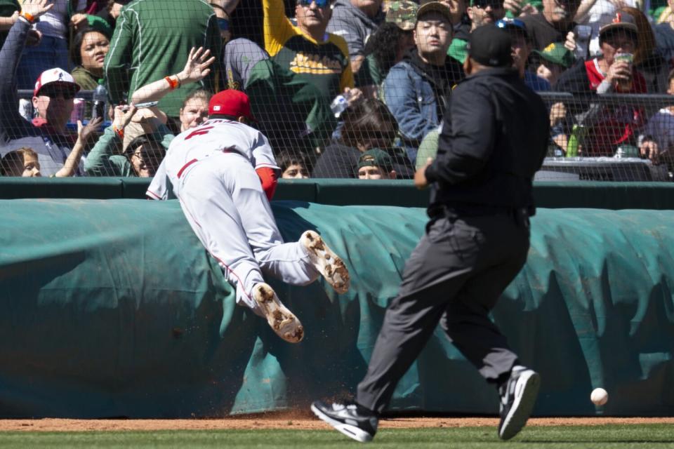 Angels third baseman Anthony Rendon crashes into a tarp while pursuing a foul pop in the fourth inning.