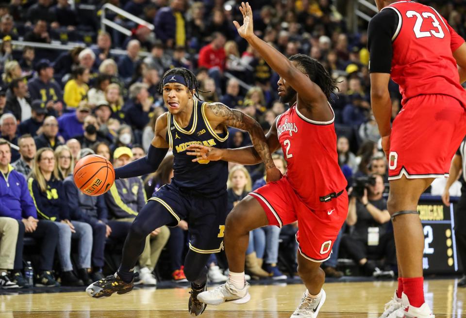 Michigan's Dug McDaniel drives against Ohio State's Bruce Thornton on Sunday.