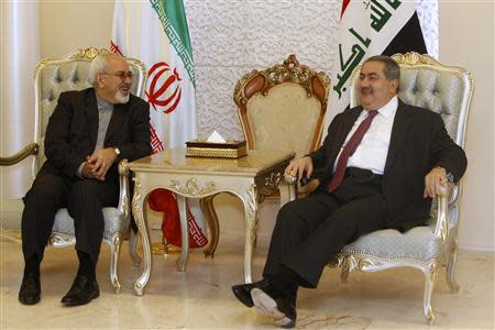 Iran's Foreign Minister Mohammad Javad Zarif meets with his Iraqi counterpart Hoshyar Zebari (R) at the Baghdad airport September 8, 2013. REUTERS/ Saad Shalash