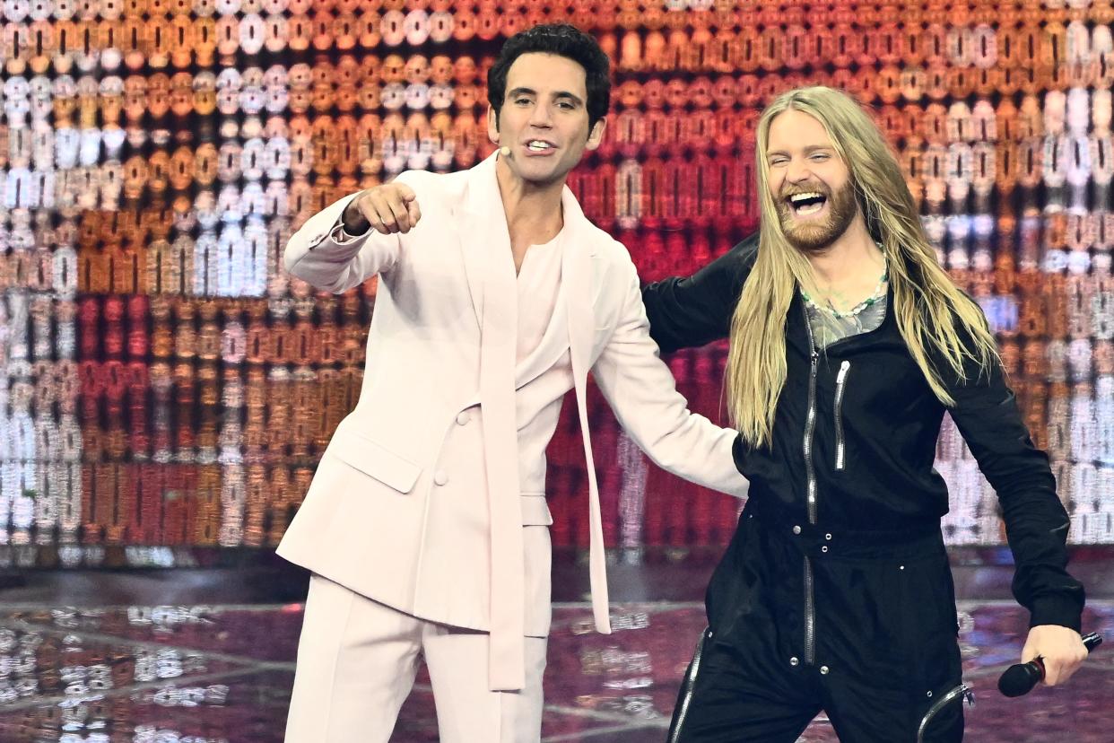 Lebanese-born British singer-songwriter, Mika (L) greets United Kingdom's singer Sam Ryder onstage during the second semifinal of the Eurovision Song contest 2022 on May 12, 2022 at the Pala Alpitour venue in Turin. (Photo by Marco BERTORELLO / AFP) (Photo by MARCO BERTORELLO/AFP via Getty Images)