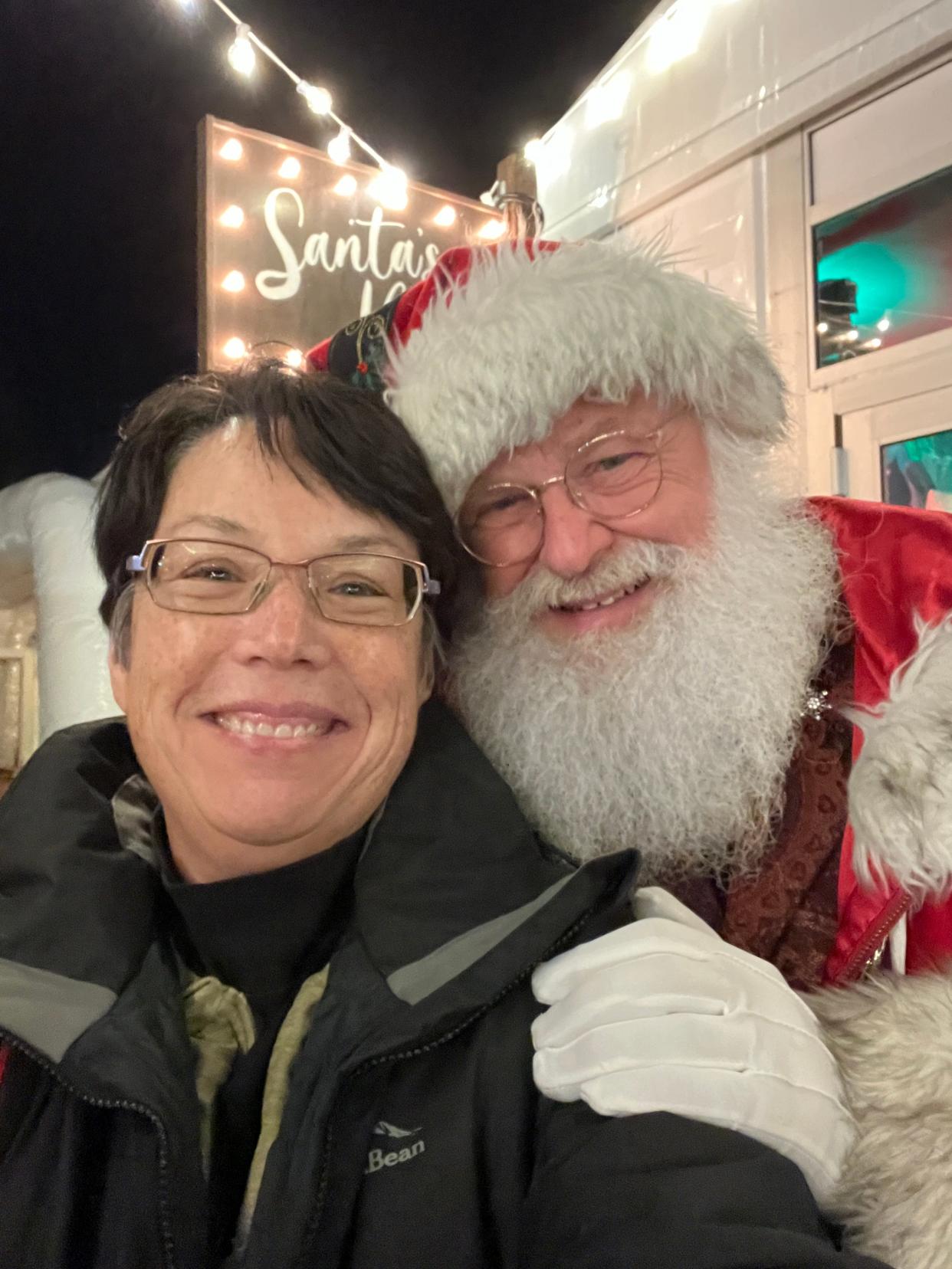 Tina MacIntyre-Yee takes a selfie with Santa Claus after spying him outside his tent at Roc Holiday Village.