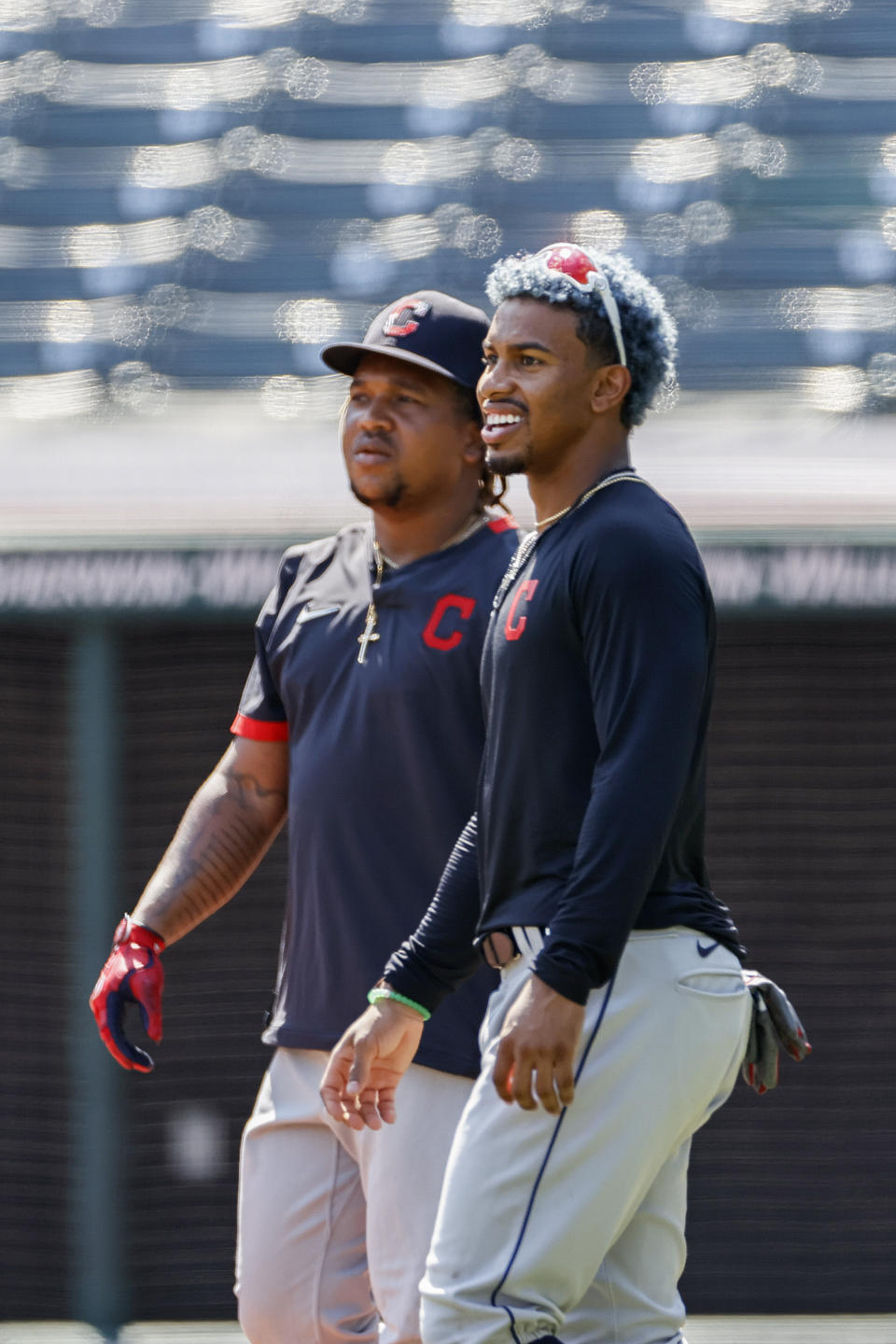 Cleveland Indians' Francisco Lindor, right, and Jose Ramirez watch batting practice during baseball practice at Progressive Field, Monday, July 6, 2020, in Cleveland. (AP Photo/Ron Schwane)