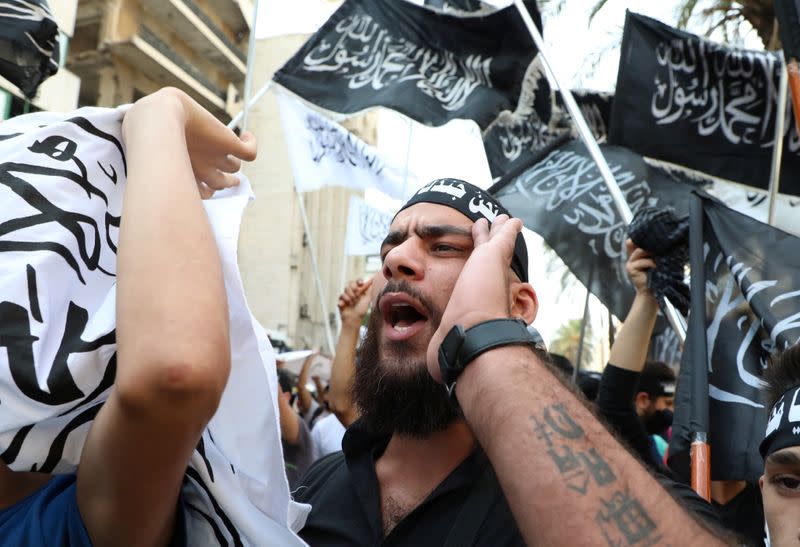 A demonstrator gestures during a protest against the cartoon publications of Prophet Mohammad in France and comments by the French President Emmanuel Macron, in Beirut