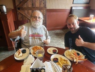 Jon Misner of Hartville (left), and son-in-law Adrian Chandler enjoy dinner at Red Lobster; a promise Chandler made if Misner recovered from his  heart procedure that took place earlier this year.