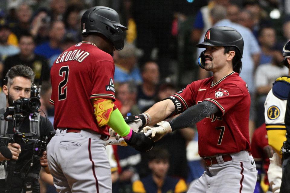 Arizona Diamondbacks shortstop Geraldo Perdomo (2) and left fielder Corbin Carroll (7) celebrate scoring in the third inning against the Milwaukee Brewers during game one of the Wildcard series for the 2023 MLB playoffs at American Family Field on Oct. 3, 2023.