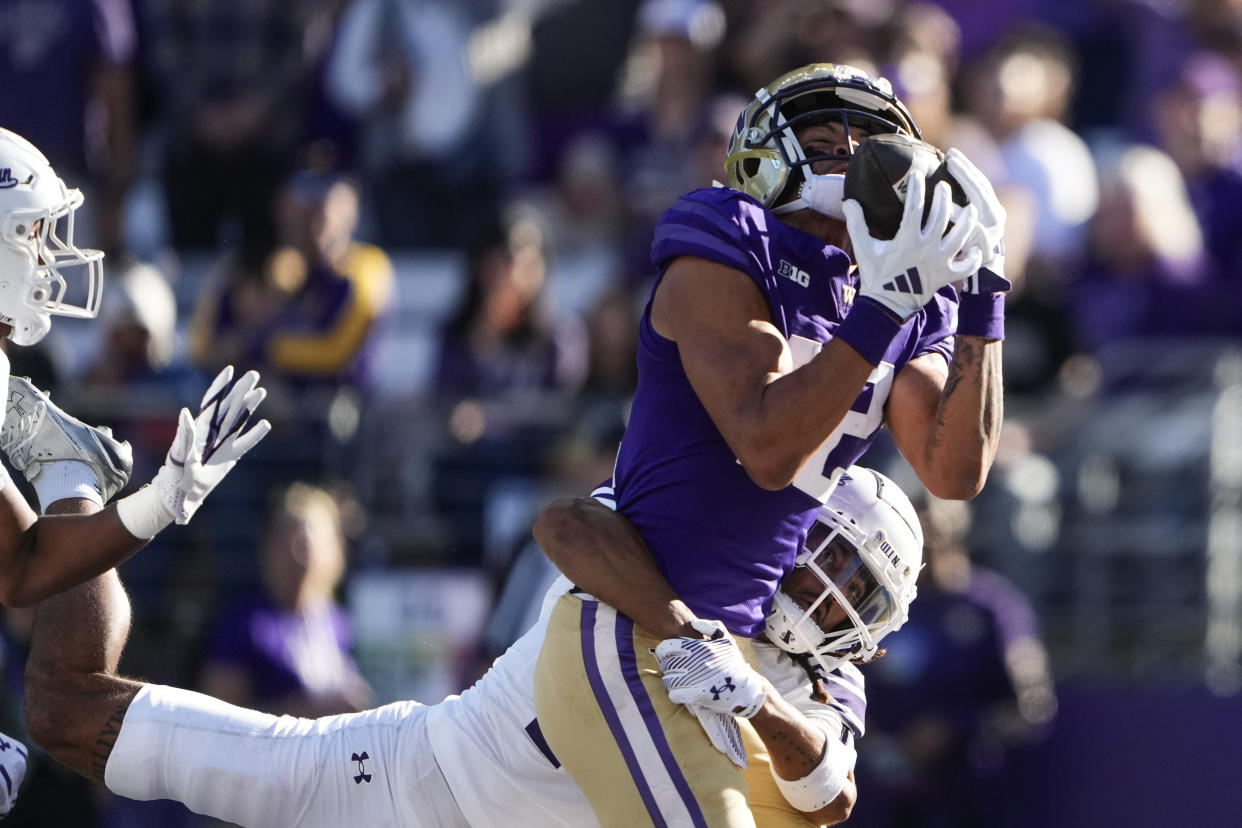 Washington wide receiver Denzel Boston catches a touchdown against Northwestern defensive back Theran Johnson during the first half of an NCAA college football game Saturday, Sept. 21, 2024, in Seattle. (AP Photo/Lindsey Wasson)