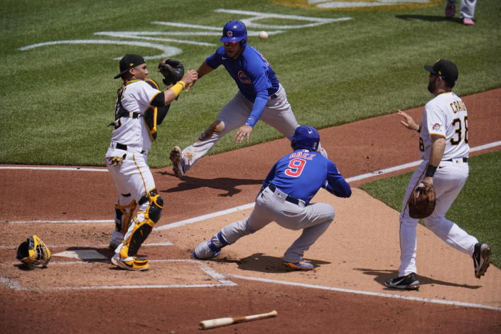 FILE - Pittsburgh Pirates first baseman Will Craig, right, tosses the ball to catcher Michael Perez, left, after Chicago Cubs' Javier Baez (9) hit a fielder's choice third to first and was caught in a rundown between home a first during the third inning of a baseball game in Pittsburgh, May 27, 2021. Cub's Willson Contreras, top center, scores on the play and Báez reached second on an errant throw by Pirates' catcher Perez. In a totally forgettable season for the Chicago Cubs, Baez wins the Newby award for best baserunning. (AP Photo/Gene J. Puskar, File)