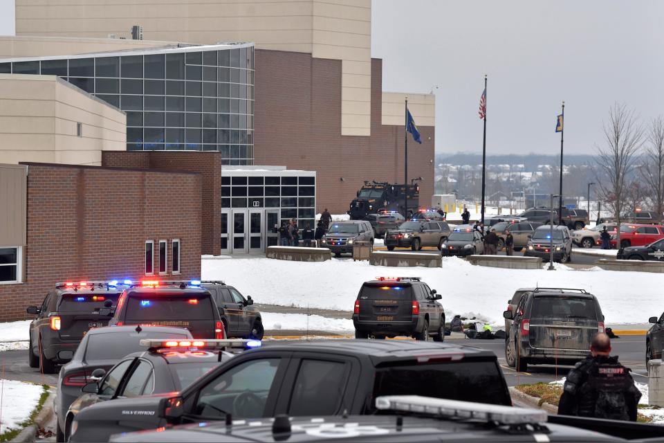 Dozens of police, fire, and EMS personnel work on the scene of a shooting at Oxford High School, Tuesday, Nov. 30, 2021, In Oxford Township, Michigan (AP)