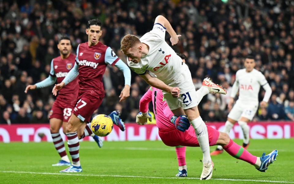 Dejan Kulusevski of Tottenham Hotspur is challenged by Lukasz Fabianski of West Ham United in the box during the Premier League match between Tottenham Hotspur and West Ham United at Tottenham Hotspur Stadium