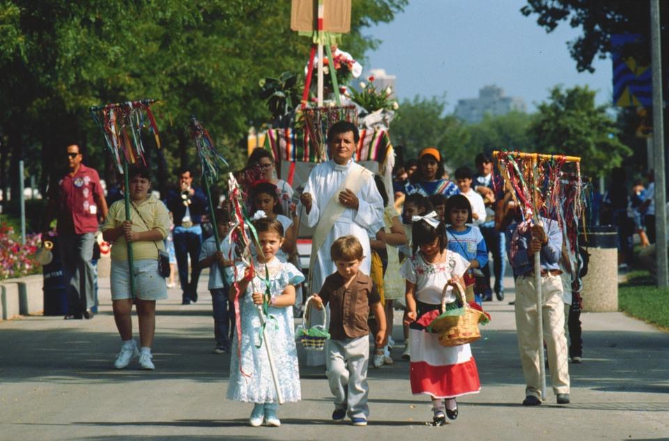 Festival-goers participate in a pre-mass procession during Mexican Fiesta in 2000.