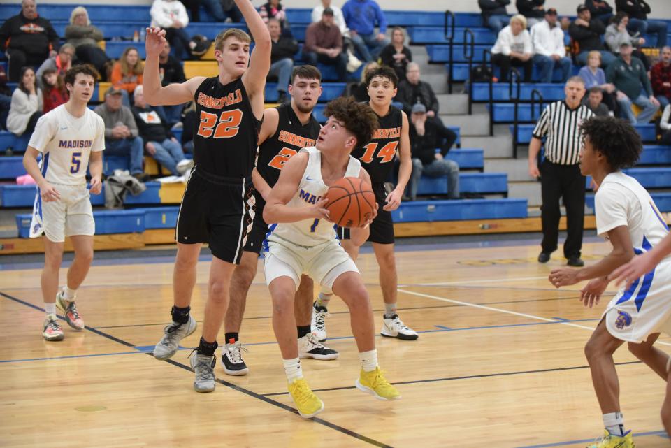 Madison's Austin Burciaga goes up for a shot while defended by Summerfield's Drew Dafoe last season.