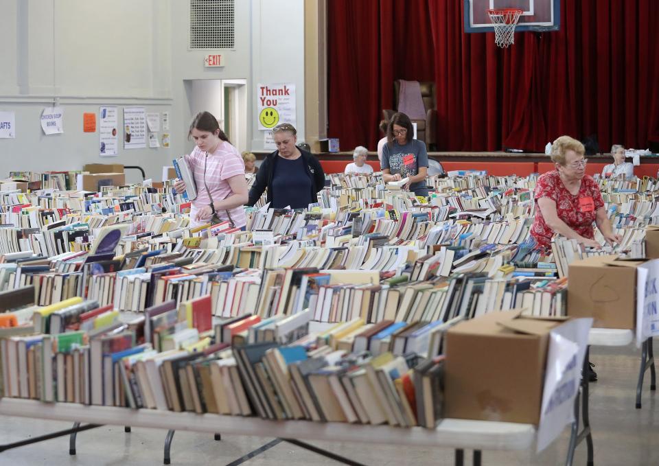 Visitors check out the hundreds of books for sale in the main auditorium Saturday, Aug. 5, 2023, at The Commons on South Linden Avenue during the Friends of Rodman Public Library's annual Used Book Sale.