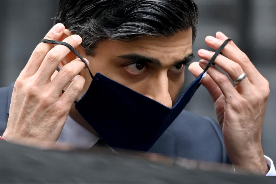 LONDON, ENGLAND - MARCH 03: Chancellor of the Exchequer, Rishi Sunak, puts on a face mask as he departs to deliver the annual Budget at 11 Downing Street on March 3, 2021 in London, England. The Chancellor, Rishi Sunak, presents his second budget to the House of Commons. He has pledged to protect jobs and livelihoods as the UK economy has faced crisis during the Coronavirus Pandemic. (Photo by Leon Neal/Getty Images)