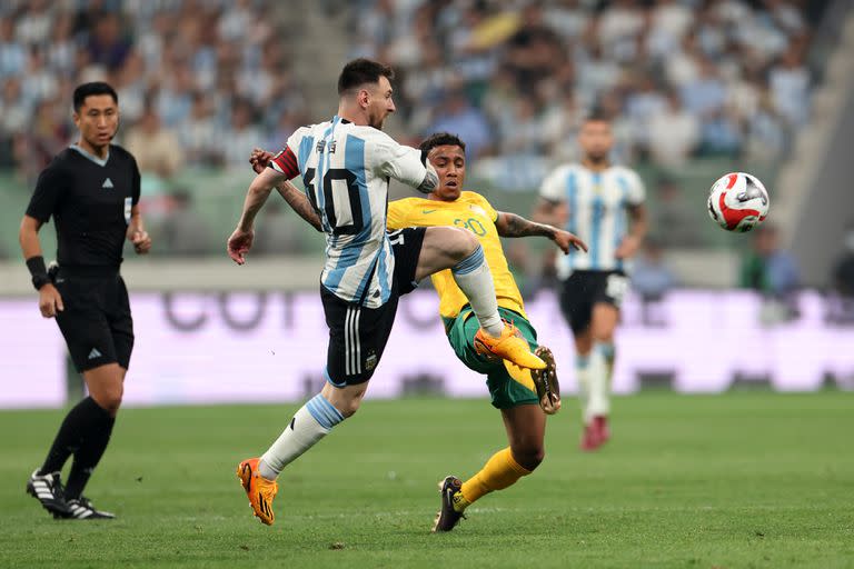 BEIJING, CHINA - JUNE 15: Lionel Messi of Argentina and Keanu Baccus of Australia compete for the ball during the international friendly match between Argentina and Australia at Workers Stadium on June 15, 2023 in Beijing, China. (Photo by Lintao Zhang/Getty Images)