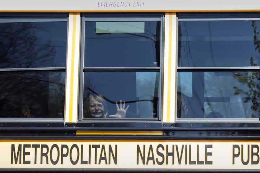 A child weeps while on the bus leaving The Covenant School following a mass shooting at the school in Nashville, Tenn., Monday, March 27, 2023. (Nicole Hester/The Tennessean via AP)