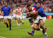 Two sides of the game are revealed in this close up shot by Mike Hewitt (Getty Images). Japan’s Timothy Lafaele goes on to score in a 38 - 19 win, but it’s a close run thing as Alapati Leiua of Samoa hangs on for dear life.