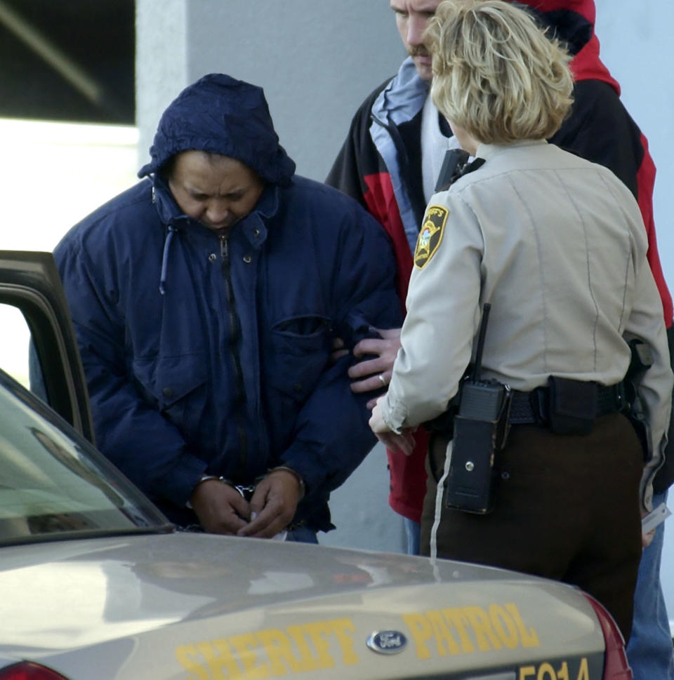 FILE - In this Dec. 3, 2003 file photo, Alfonso Rodriguez Jr., left, is helped into a sheriff's car after waiving extradition at the Polk County Courthouse in Crookston, Minn. A federal judge on Friday, Sept. 3, 2021, threw out the death sentence for Alfonso Rodriguez Jr convicted in the 2003 slaying of Dru Sjodin, a North Dakota college student. (AP Photo/Ann Heisenfelt File)