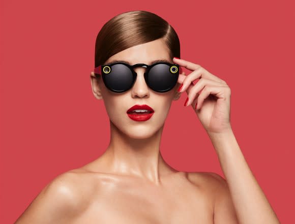 A woman wearing Snap Spectacles