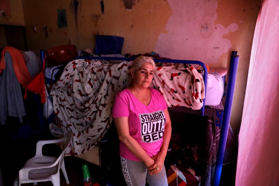 A woman standing beside a bunkbed