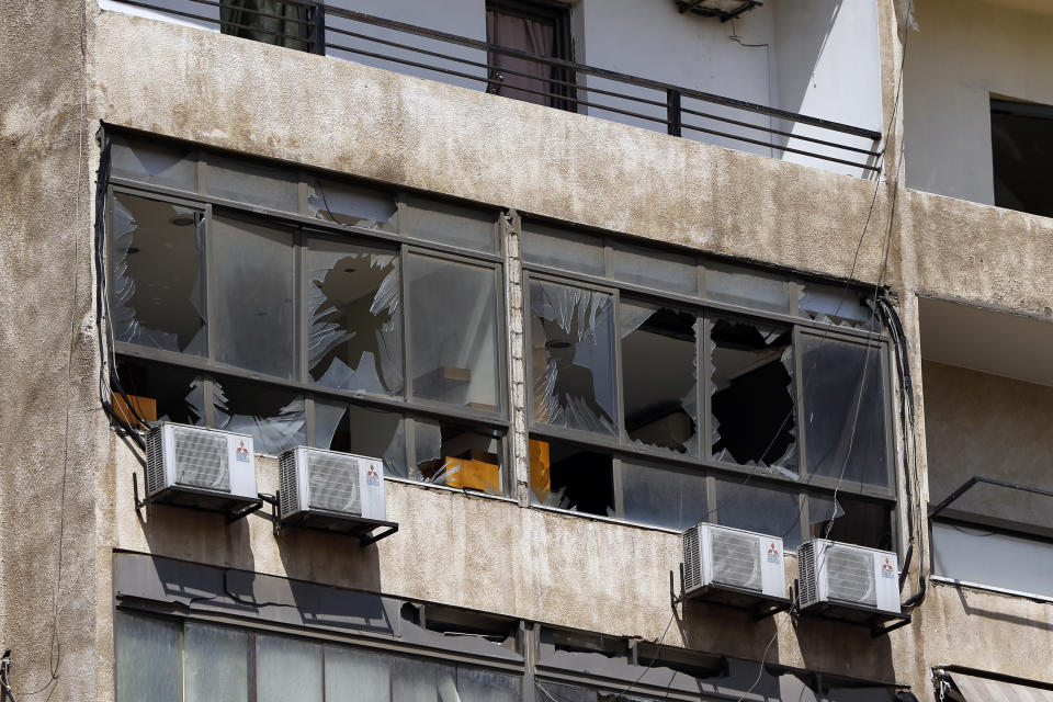 Broken windows are seen on the 11-floor building that houses the media office in a stronghold of the Lebanese Hezbollah group in a southern suburb of Beirut, Lebanon, Sunday, Aug. 25, 2019. Two Israeli drones crashed in a Hezbollah stronghold in the Lebanese capital overnight without the militants firing on them, a spokesman for the group said Sunday, saying the first fell on the roof of a building housing Hezbollah's media office while the second landed in a plot behind it. (AP Photo/Bilal Hussein)