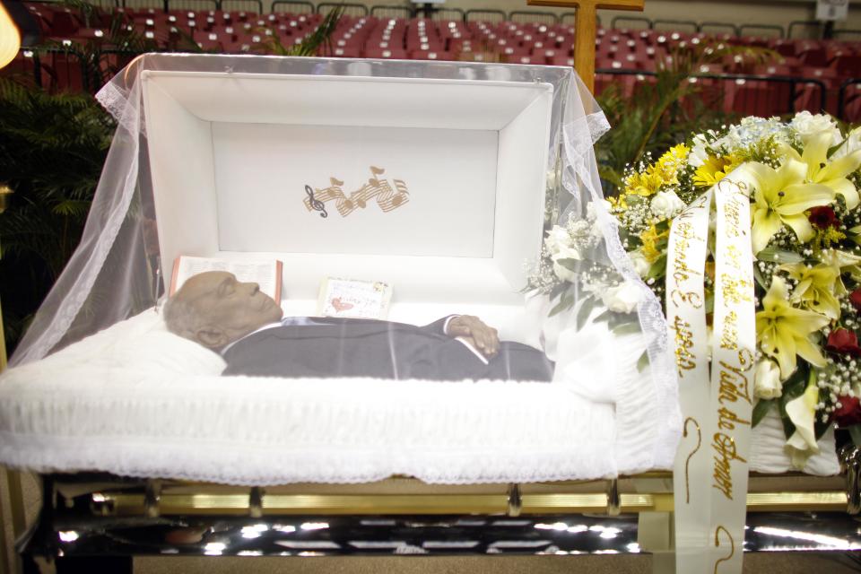 The body of Cheo Feliciano lies in an open casket during his funeral at the San Juan Coliseum in Puerto Rico, Saturday April 19, 2014. Feliciano, a member of the Fania All Stars died in a car crash early Thursday morning when he hit a light post before dawn in the northern suburb of Cupey in San Juan. (AP Photo/Ricardo Arduengo)