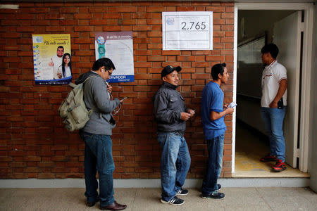 Residents wait in a queue to vote at a polling station during a referendum on a border dispute with Belize in Mixco, on the outskirts of Guatemala City, Guatemala April 15, 2018. REUTERS/Luis Echeverria