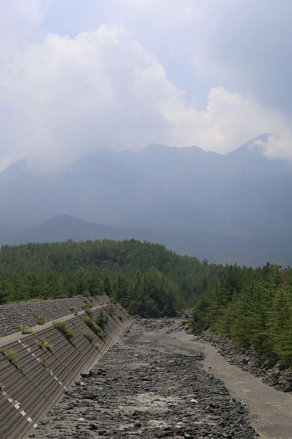 Sakurajima volcano is seen in Kagoshima, southern island of Kyushu, Japan, one day after its eruption, Monday, July 25, 2022. The volcano spewed ash and large rocks into the nighttime sky on Sunday. (Kyodo News via AP)