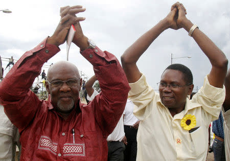 FILE PHOTO: Independent presidential candidate Simba Makoni (R) and former Zimbabwe minister of Home Affairs Dumiso Dabengwa salute supporters during the launch of his presidential election campaign at White City Stadium, in Bulawayo, March 1, 2008. REUTERS/Emmanuel Chitate/File Photo