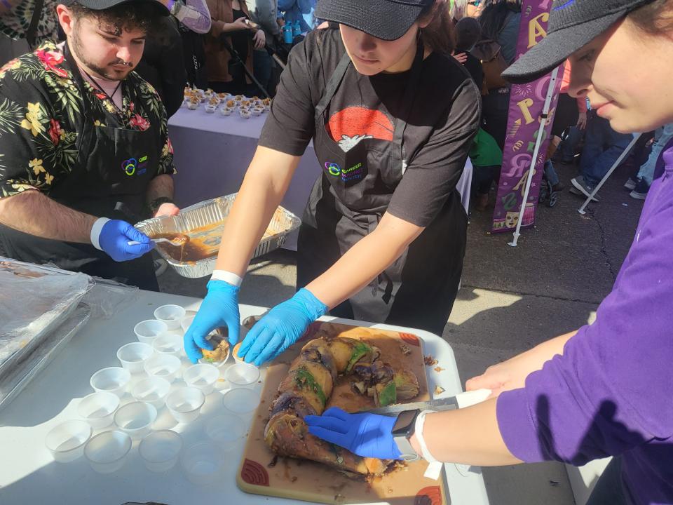 Damien Callias, Paige Ledet, and Kalena Dehart, prepare bite-size portions of their king cake for attendees at the Bayou King Cake Festival, held Saturday, Feb. 4, 2023, in downtown Thibodaux. The students represented the Lafourche Career Magnet Center's Culinary Department.