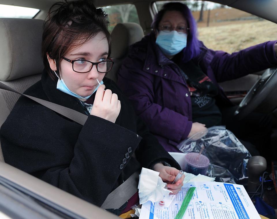 Caitlyn O'Leary, of Maynard, takes a COVID-19 test at the Mass. Dept. of Public Health Stop the Spread testing site, run by the Marlborough Hospital, at the Marlborough Sports Center, Jan. 3, 2022.