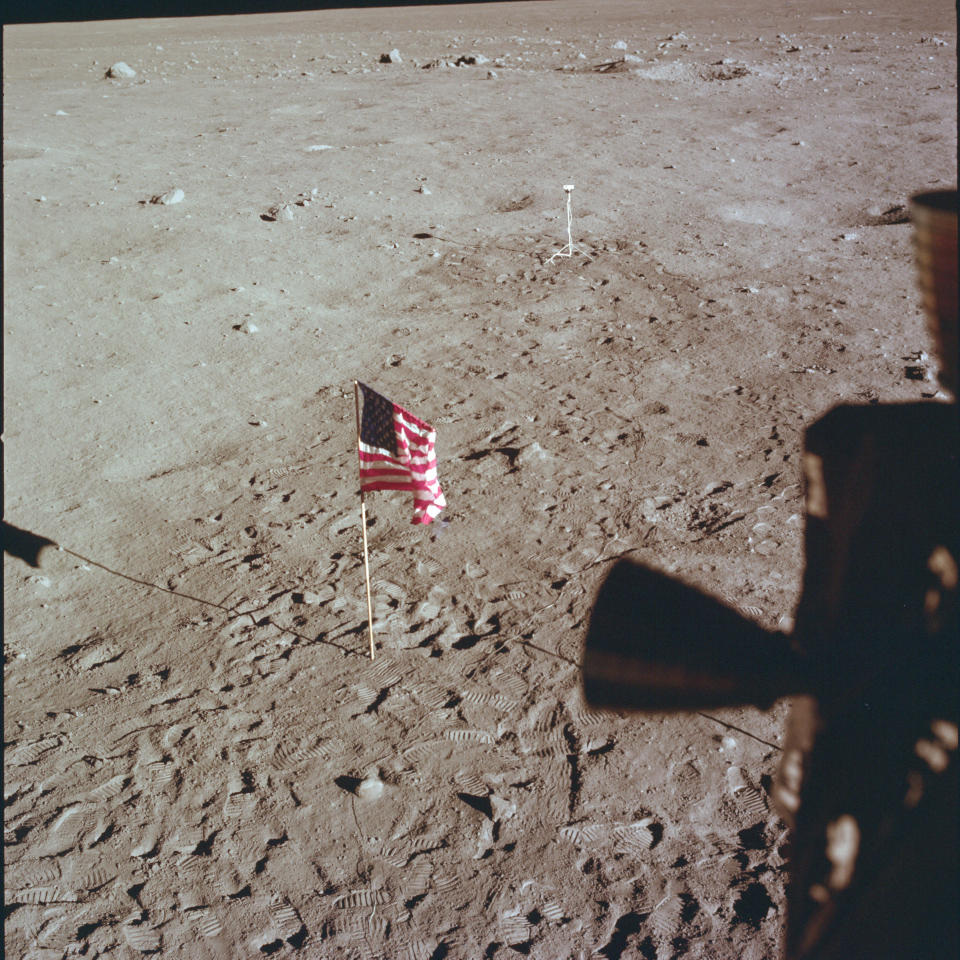 This July 21, 1969 photo made available by NASA shows Tranquility Base and the U.S. flag from a window on the Lunar Module as Neil Armstrong and Buzz Aldrin prepare for liftoff from the surface of the moon. (NASA via AP)